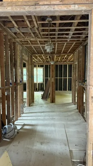 Corridor of a Montreal plex stripped back to the framing during a major renovation