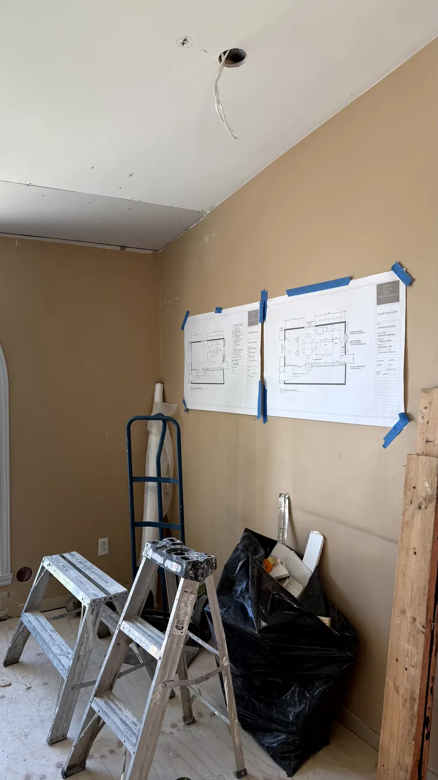Drawings posted on the site wall to coordinate the trades
