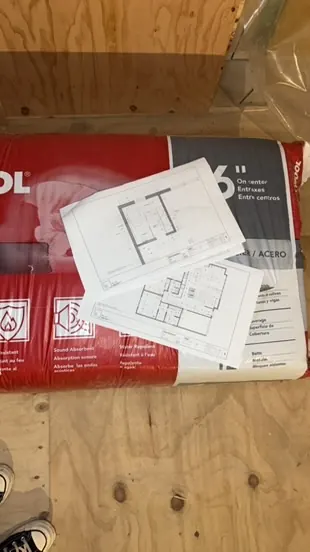 Construction drawings laid out on materials at a Kasa job site