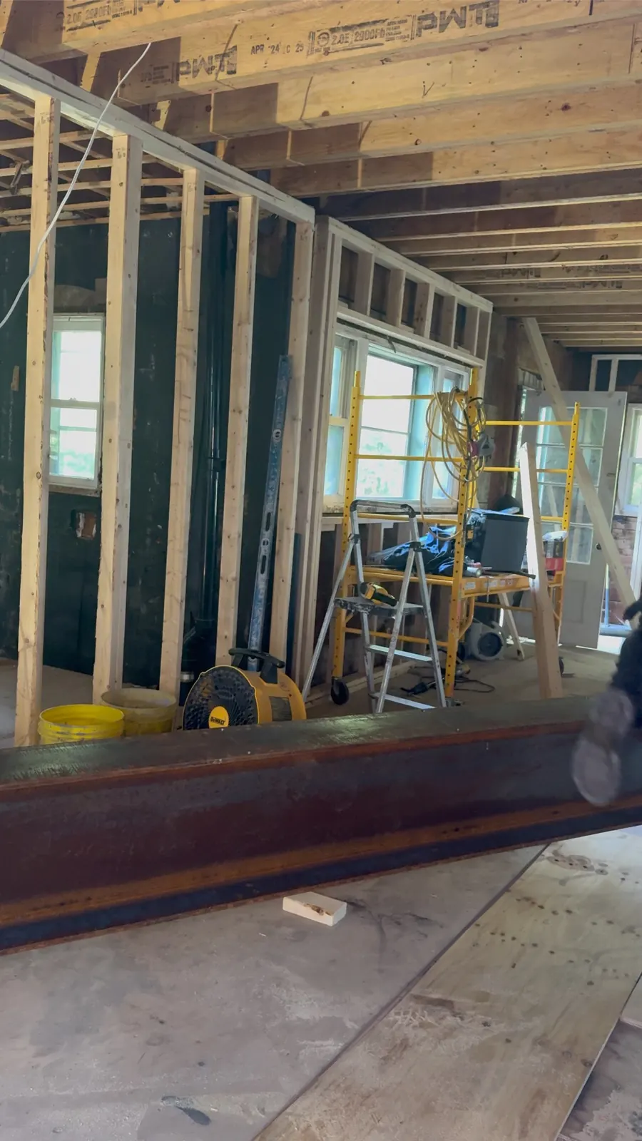 Home addition with main beam in place and new window openings